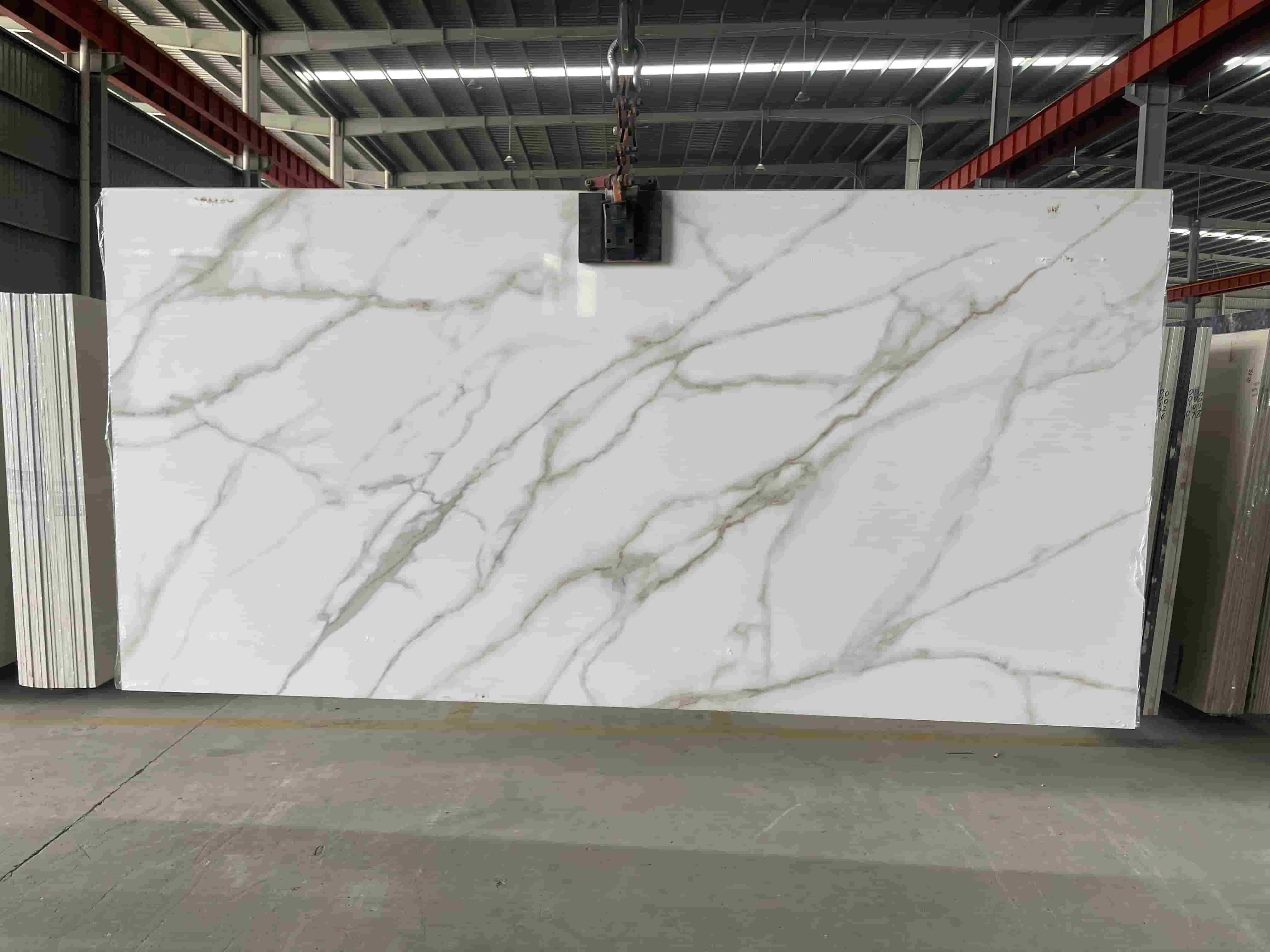 Large white marble look sintered stone slab before kitchen countertop fabrication