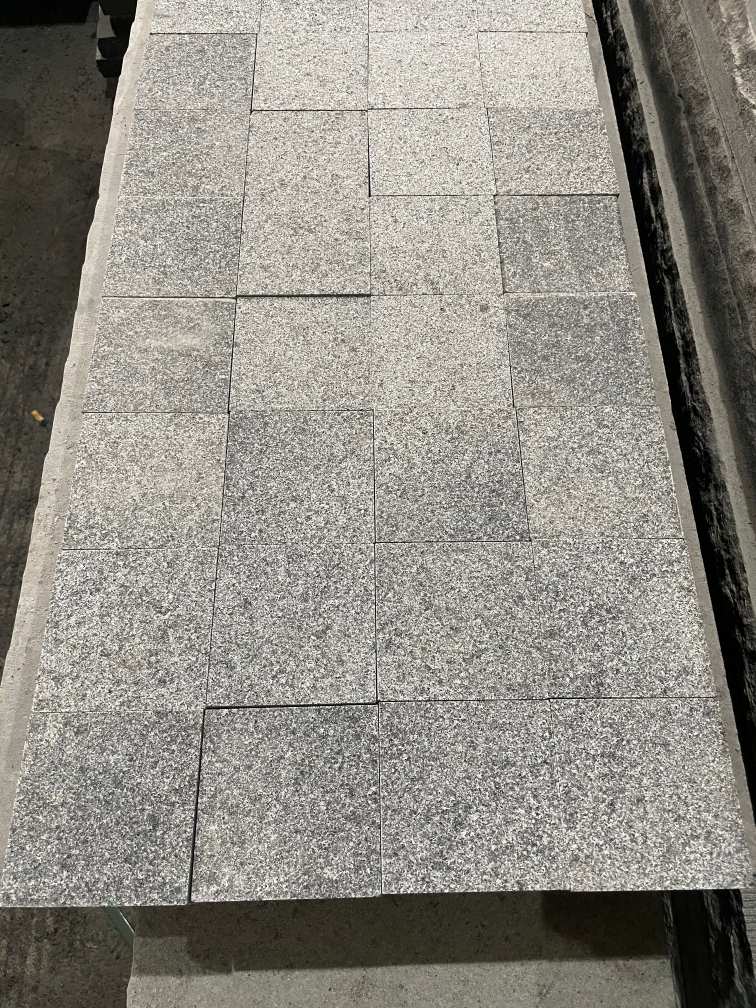 Granite pavers and cobblestones arranged for patio and traditional courtyard paving.
