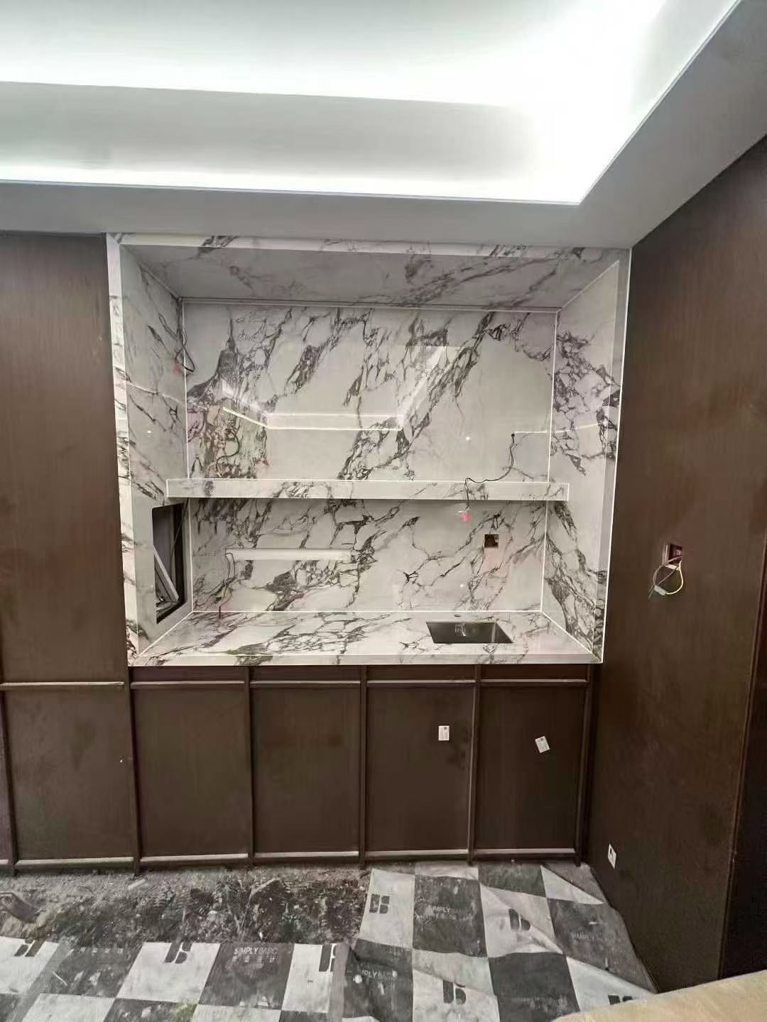 Custom Calacatta Viola marble wet bar countertop and built-in stone furniture