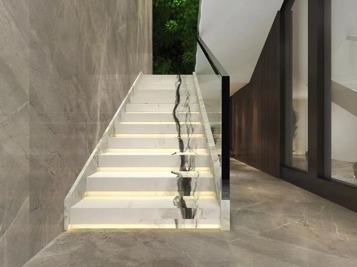 Bold Black Vein Oriental Calacatta White Marble Stairs Oriental Calacatta White marble stair treads with bold black veins continuing across successive steps