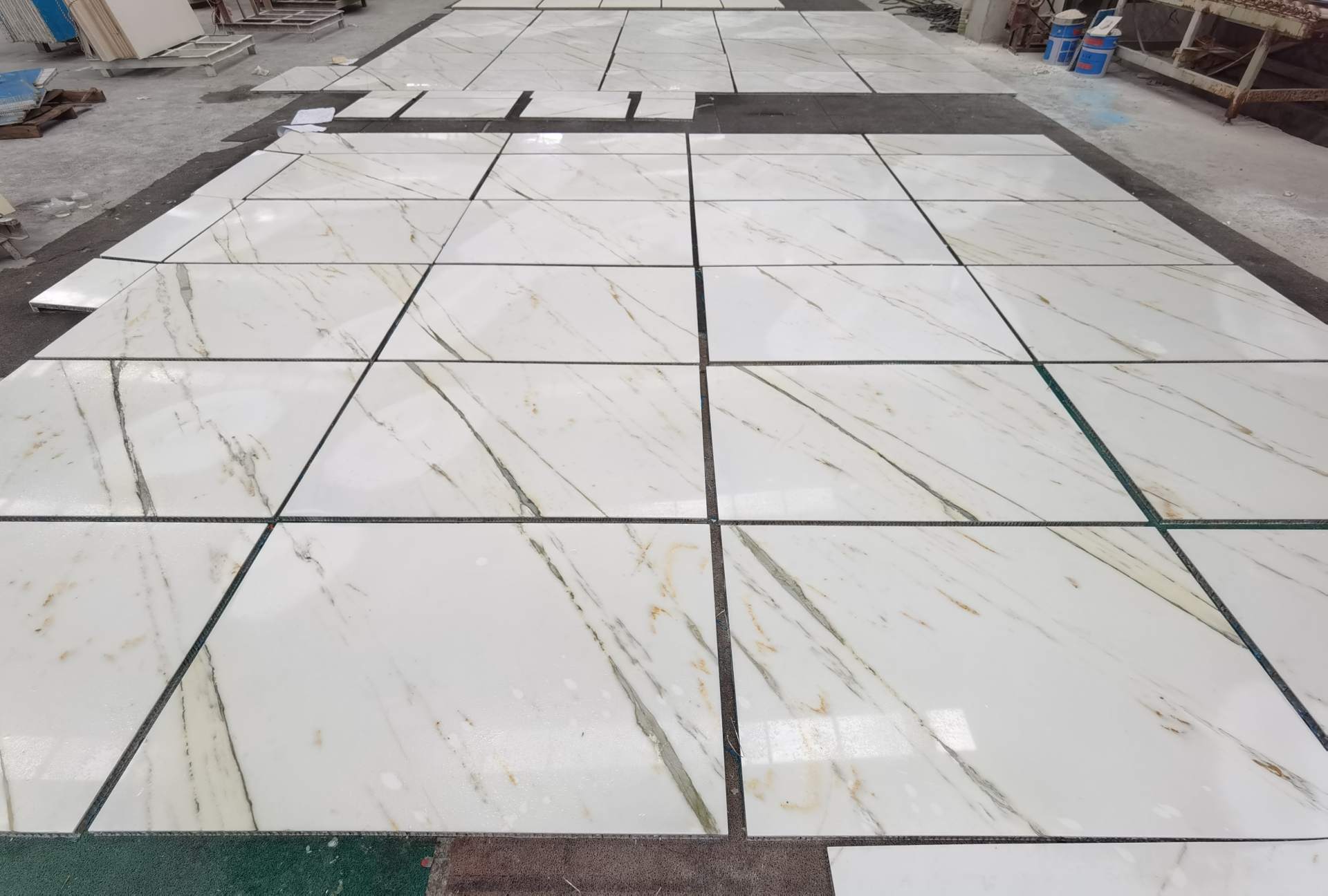Oriental Calacatta White Floor Tile Factory Pre-Layout Oriental Calacatta White floor tiles pre-laid in the factory with fine black and light warm veining