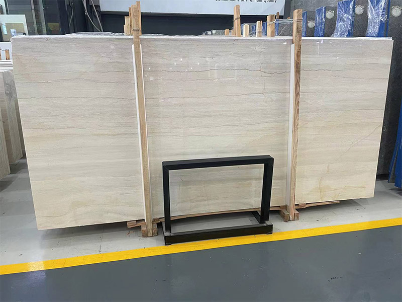 White wood-grain marble slab with linear grey bands and directional movement